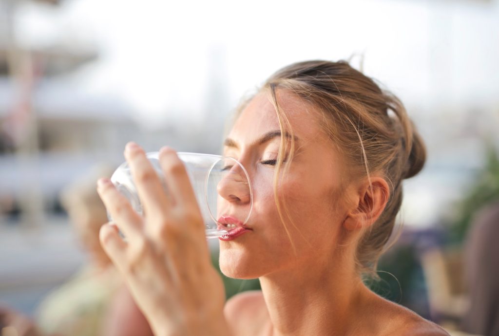 woman drinking water. skin care tips 3